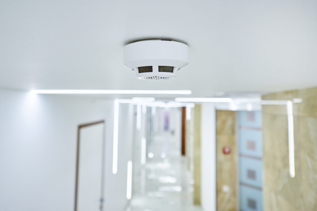 Smoke alarm mounted on ceiling during rental property safety check in Melbourne