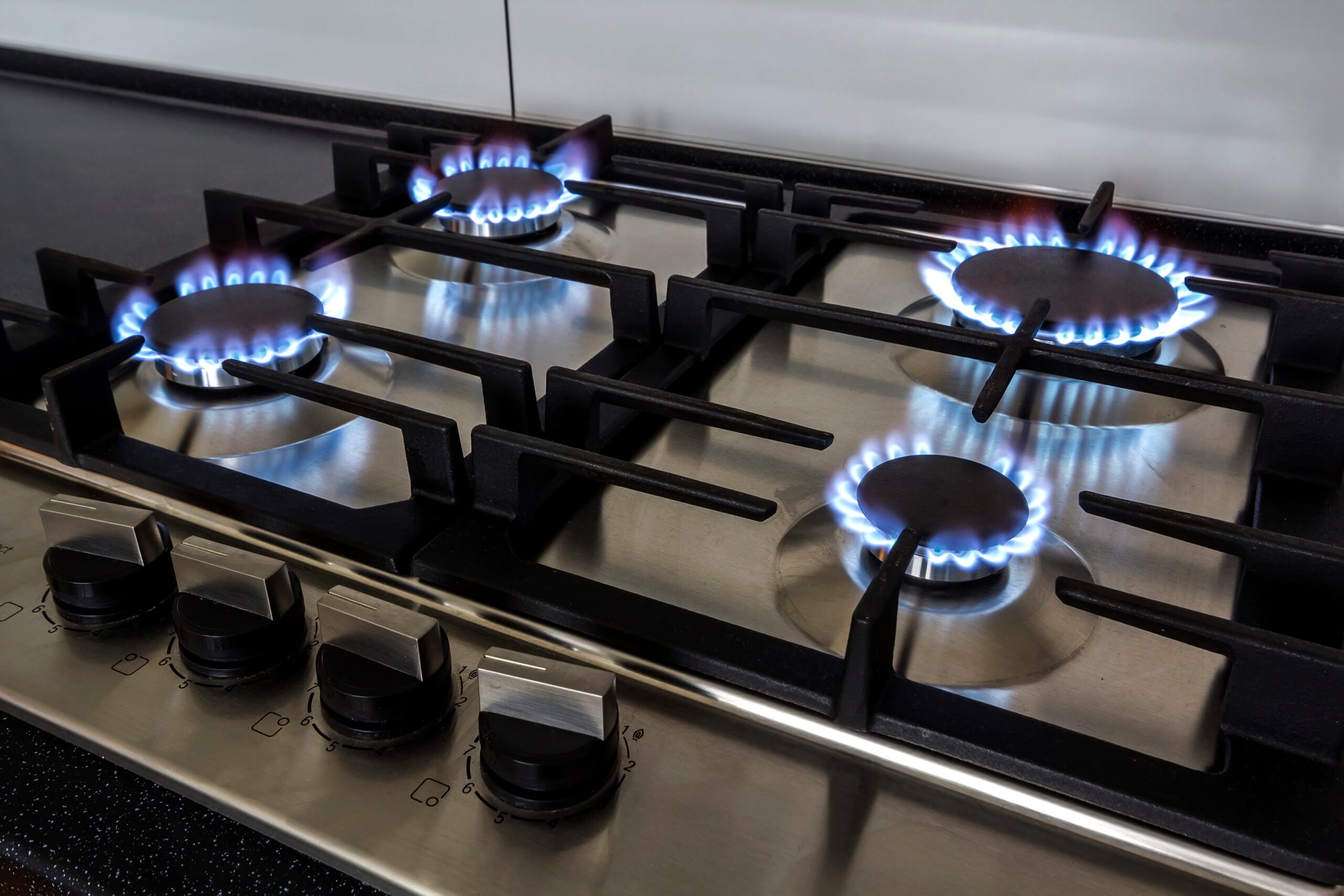 Gas stove burners operating during a rental property gas safety check in Melbourne