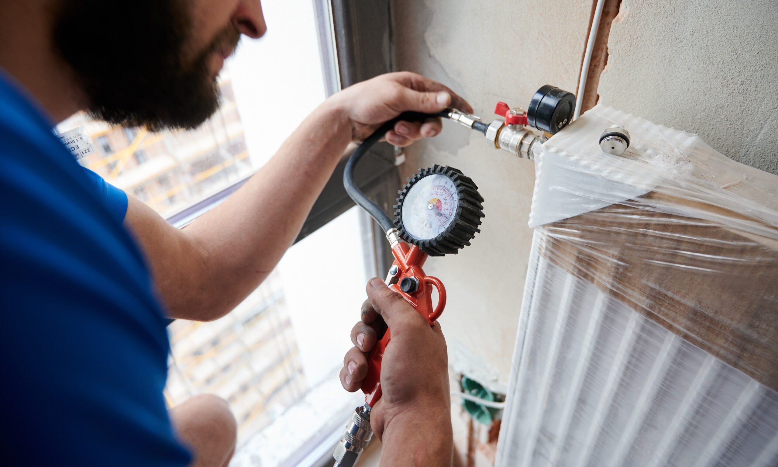 Technician performing a gas safety pressure test during a rental inspection in Melbourne