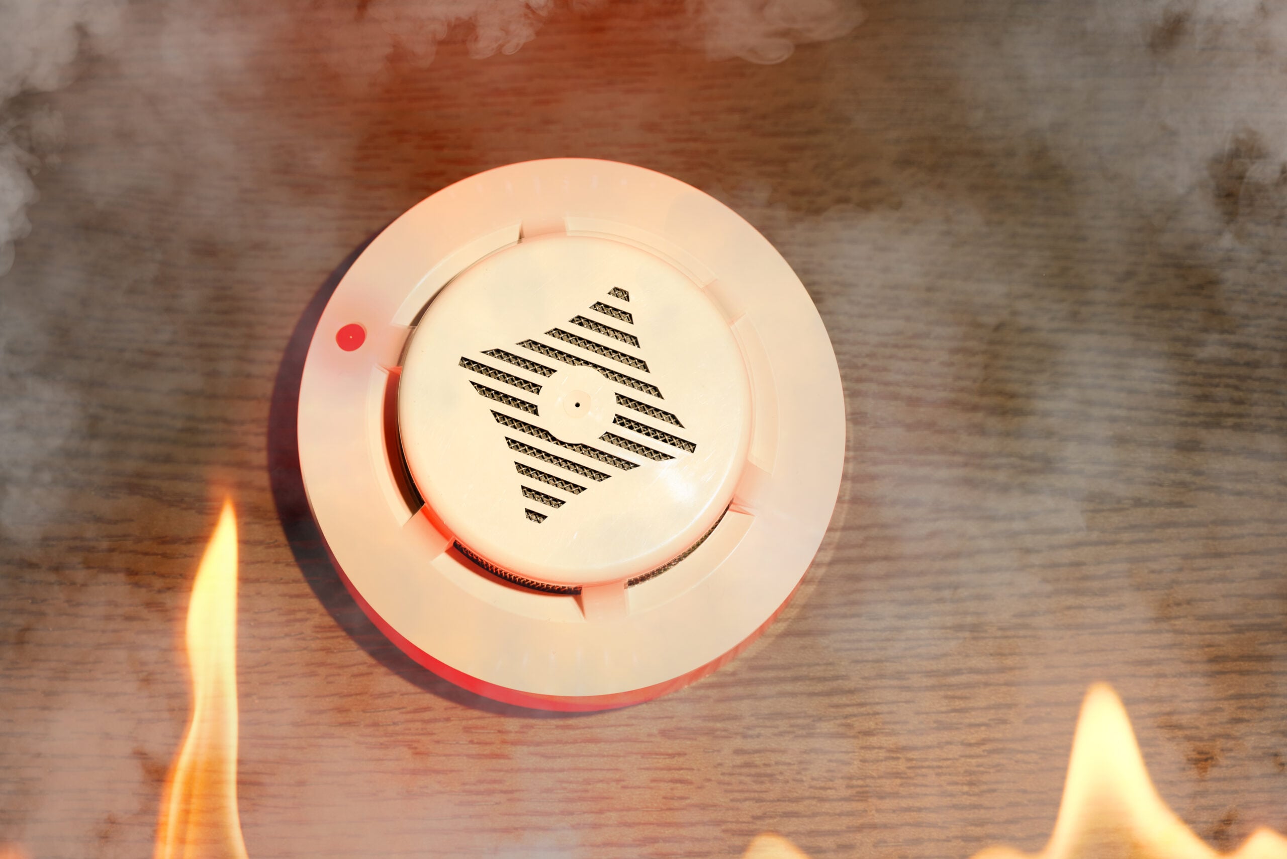 Professional installing smoke alarm on ceiling for smoke alarm safety Victoria compliance